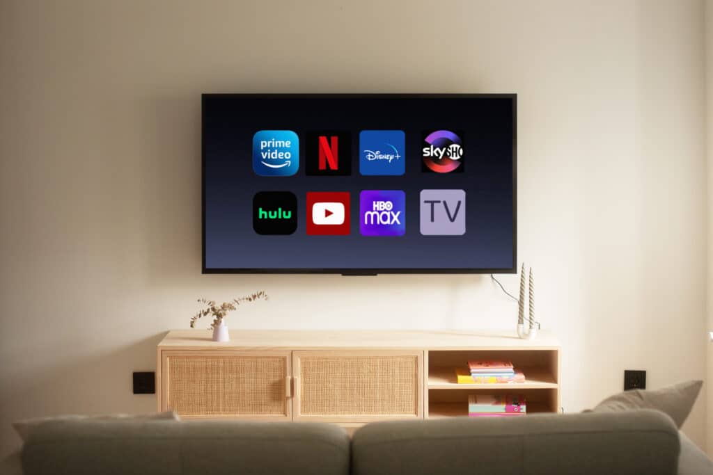 A TV inside a house, with icons of different video streaming platforms